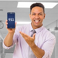 A man showing how to dial 911 on a phone.