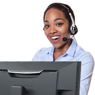 An African American female wearing a headset in front of her computer helping customers.