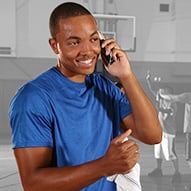Adult African American male having a conversation on the telephone.
